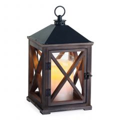 Dark bronze metal lantern candle warmer with a candle glowing inside